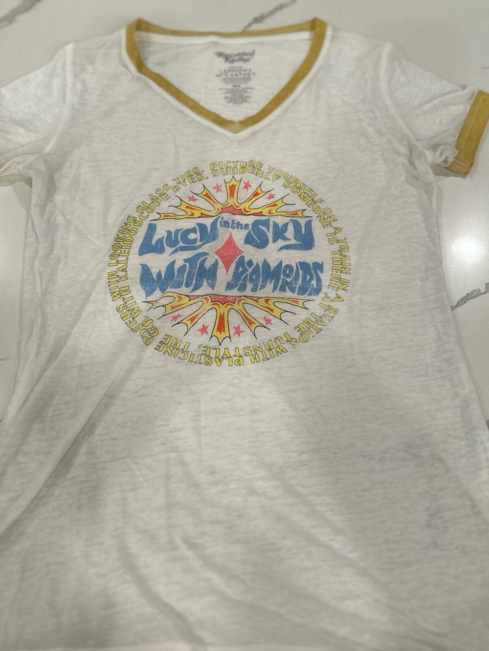 Recycled Karma White V-Neck Tee with Mustard Trim and Blue Graphic